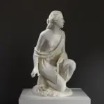 Escultura de Rut Gleaning en posición de rodillas recogiendo espigas.
